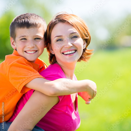 Photo: Happy mother and son outdoor portrait Happy mother and son outdoor portrait