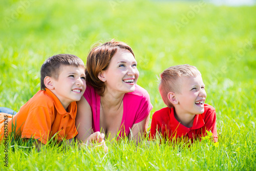 Photo: Young happy mother with children in park Young happy mother with children in park