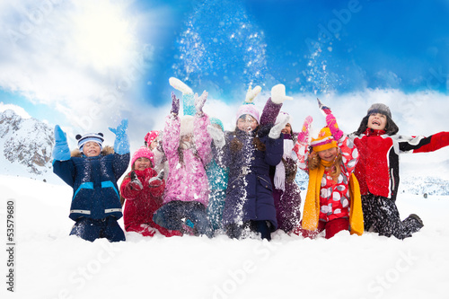 Photo: Group of happy kids throwing snow Group of happy kids throwing snow