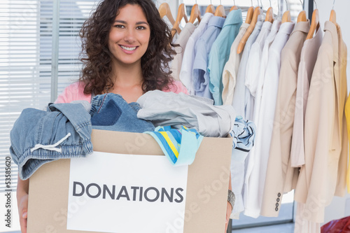 Photo: Volunteer holding clothes donation box Volunteer holding clothes donation box