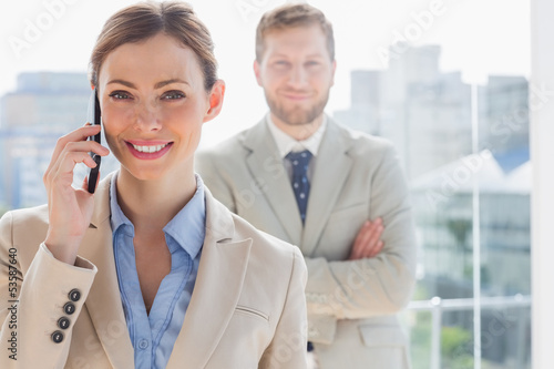 Photo: Smiling businesswoman having phone conversation Smiling businesswoman having phone conversation