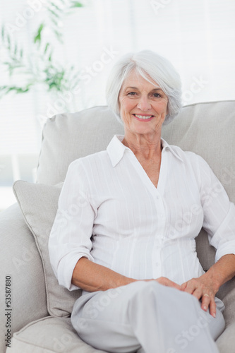 Photo: Woman sitting on a couch Woman sitting on a couch