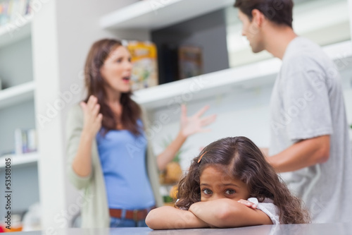 Photo: Sad girl listening to her parents arguing Sad girl listening to her parents arguing