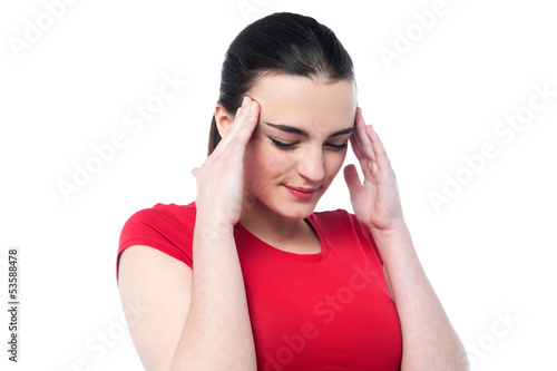 Photo: Young girl having serious headache Young girl having serious headache