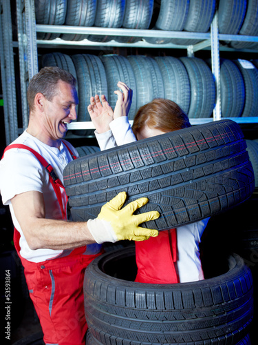 Photo: Ridiculous motor mechanic in a garage has a lot of fun at work Ridiculous motor mechanic in a garage has a lot of fun at work