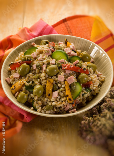 Photo: spelt sald with vegetables and ham, selective focus spelt sald with vegetables and ham, selective focus