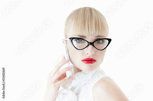 Photo: Sexy blonde business executive using smartphone. Sexy blonde business executive using smartphone.