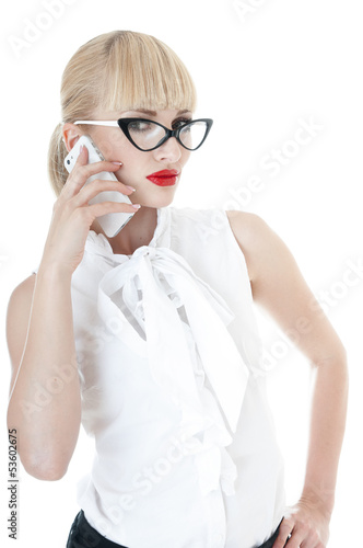 Photo: Sexy blonde business executive using smartphone. Sexy blonde business executive using smartphone.