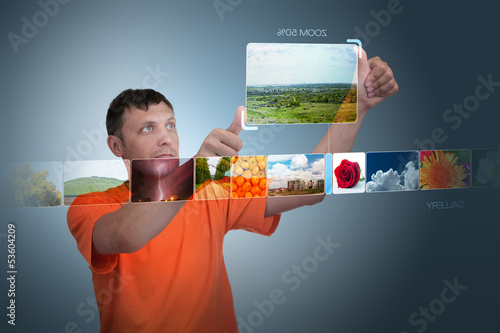 Photo: Man looks at photos of the virtual display Man looks at photos of the virtual display