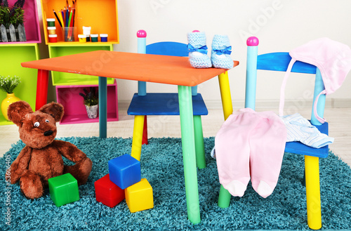 Photo: Small and colorful table and chairs with baby clothes Small and colorful table and chairs with baby clothes