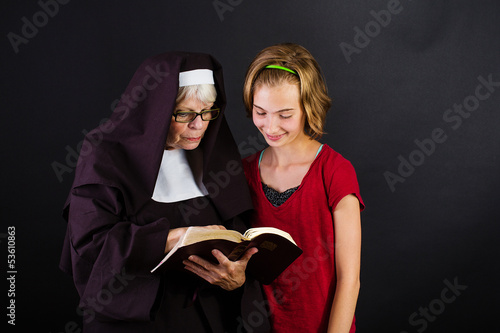 Photo: nun reading bible to a child nun reading bible to a child