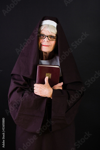 Photo: friendly nun holding bible friendly nun holding bible