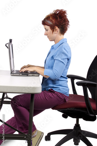 Photo: young woman demonstrating office desk posture young woman demonstrating office desk posture