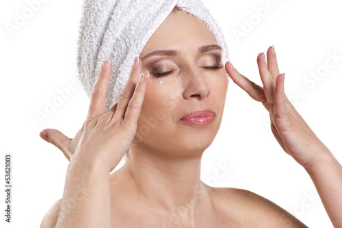 Photo: middle-aged woman with cream for eyes middle-aged woman with cream for eyes