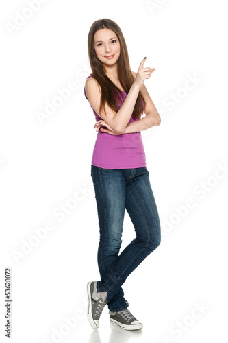 Photo: Female in full length pointing to the side at blank copy space Female in full length pointing to the side at blank copy space