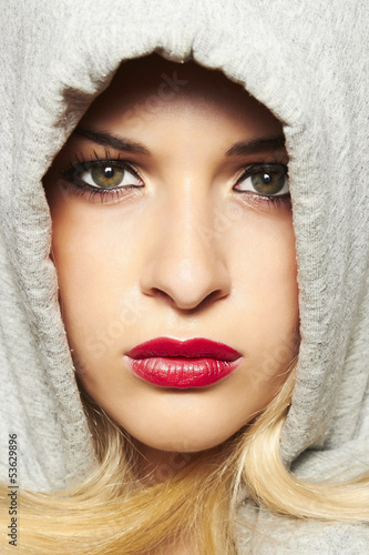 Photo: beautiful blond woman in hood. red lips beautiful blond woman in hood. red lips