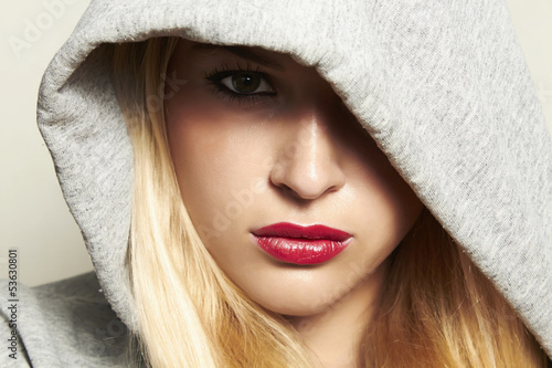 Photo: beautiful blond woman in hood. red lips. beautiful blond woman in hood. red lips.