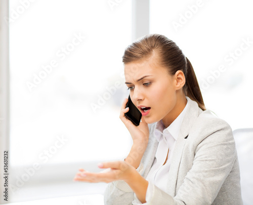 Photo: woman shouting into smartphone woman shouting into smartphone