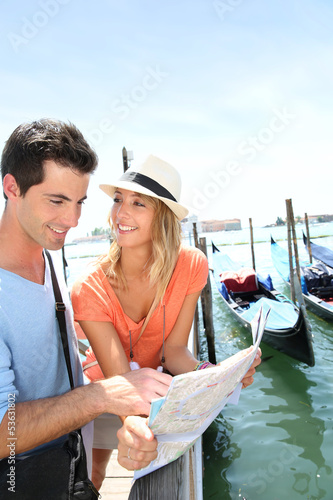 Photo: Tourists looking at map in Venice Tourists looking at map in Venice