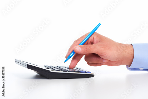Photo: Hand with a calculator. Hand with a calculator.