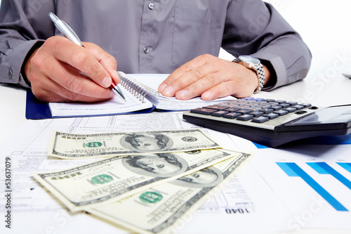 Photo: Hands of businessman with calculator. Hands of businessman with calculator.