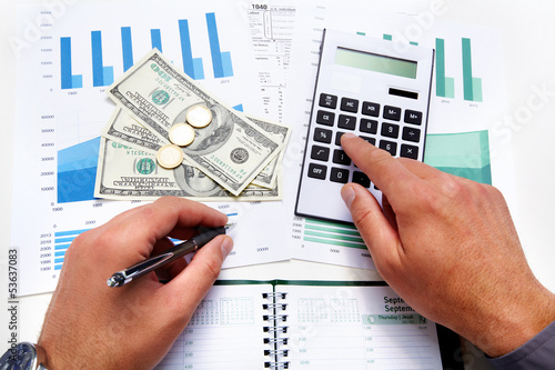 Photo: Hands of businessman with calculator. Hands of businessman with calculator.