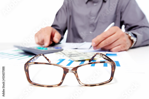 Photo: Hands of businessman with calculator. Hands of businessman with calculator.