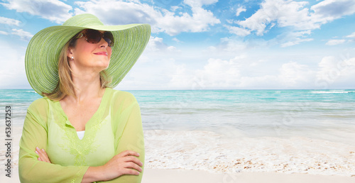 Photo: Senior woman wearing sunglasses and a hat. Senior woman wearing sunglasses and a hat.