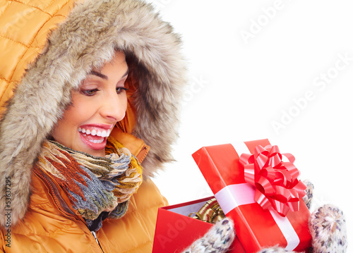 Photo: Beautiful young Christmas girl with a present. Beautiful young Christmas girl with a present.