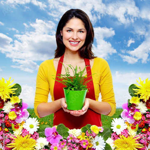 Photo: Gardening woman with plant. Gardening woman with plant.