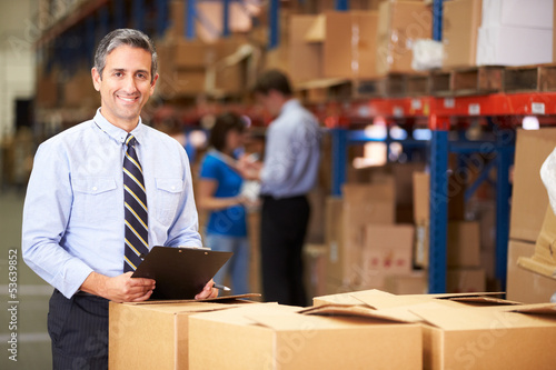 Photo: Manager In Warehouse Checking Boxes Manager In Warehouse Checking Boxes