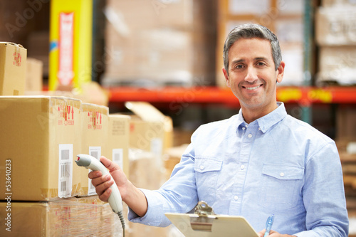 Photo: Worker Scanning Package In Warehouse Worker Scanning Package In Warehouse
