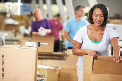 Photo: Workers In Warehouse Preparing Goods For Dispatch Workers In Warehouse Preparing Goods For Dispatch