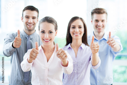 Photo: Business team with thumbs up Business team with thumbs up