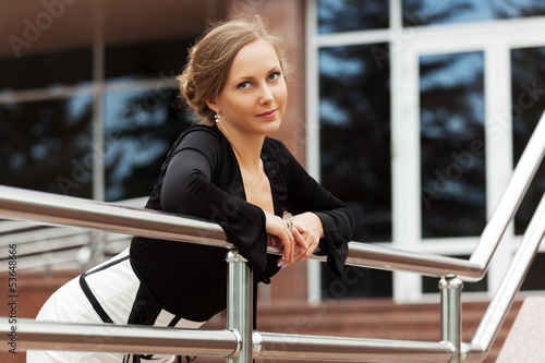 Photo: Beautiful woman against office windows Beautiful woman against office windows
