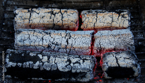 Photo: glowing embers from wooden briquettes glowing embers from wooden briquettes