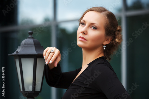Photo: Sad beautiful woman at lamppost Sad beautiful woman at lamppost