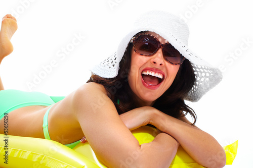 Photo: Woman wearing sunglasses and a hat. Woman wearing sunglasses and a hat.