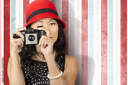 Photo: Pin-up photographer in 40s fashion holding camera Pin-up photographer in 40s fashion holding camera