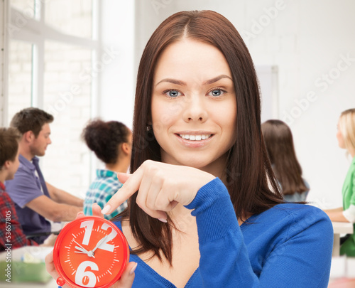 Photo: girl holding big clock at school girl holding big clock at school