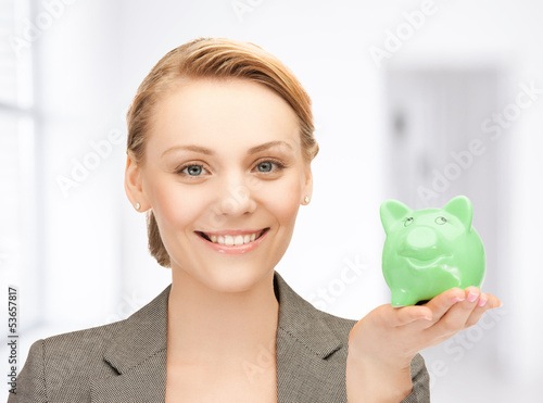 Photo: lovely woman with small piggy bank lovely woman with small piggy bank