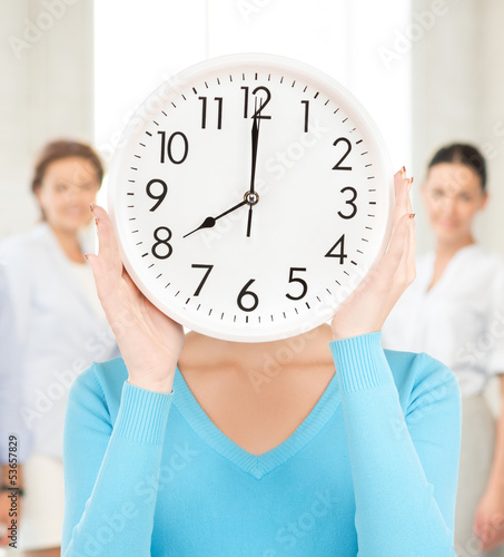 Photo: businesswoman with clock over her face businesswoman with clock over her face