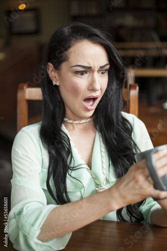 Photo: Beautiful Young Woman Shocked by What's in Her Coffee Cup Beautiful Young Woman Shocked by What's in Her Coffee Cup