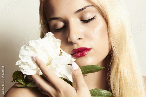Photo: beautiful blond woman with white flower beautiful blond woman with white flower