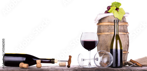 Photo: grapes on a barrel with corkscrew and wine glass grapes on a barrel with corkscrew and wine glass