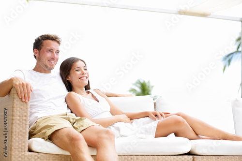 Photo: Couple relaxing together in sofa Couple relaxing together in sofa