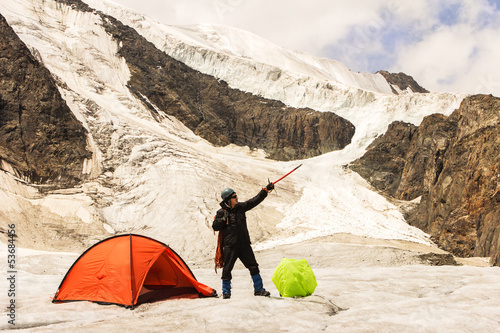 Photo: The climber costs on glacier near tent The climber costs on glacier near tent