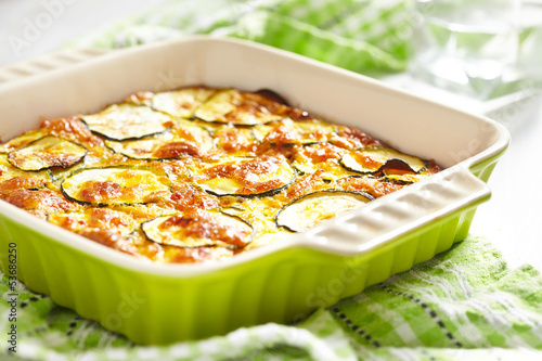 Photo: casserole with cheese and zucchini in baking dish casserole with cheese and zucchini in baking dish