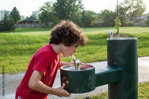 Photo: Child drinking from a water fountain Child drinking from a water fountain