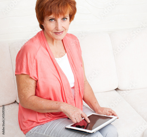 Photo: Mature woman with tablet pc Mature woman with tablet pc
